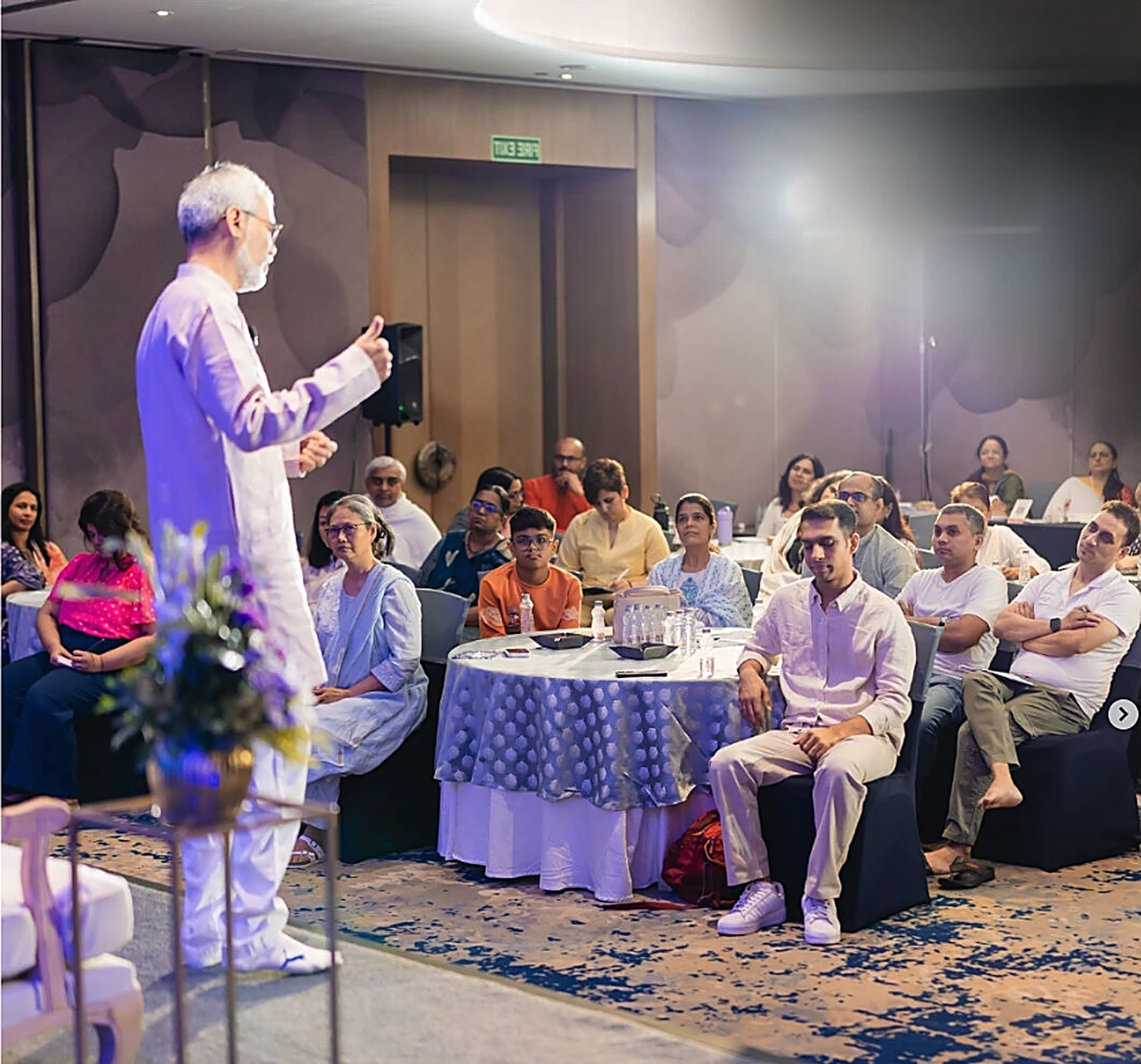Vibhushri speaking to a seated audience at a workshop