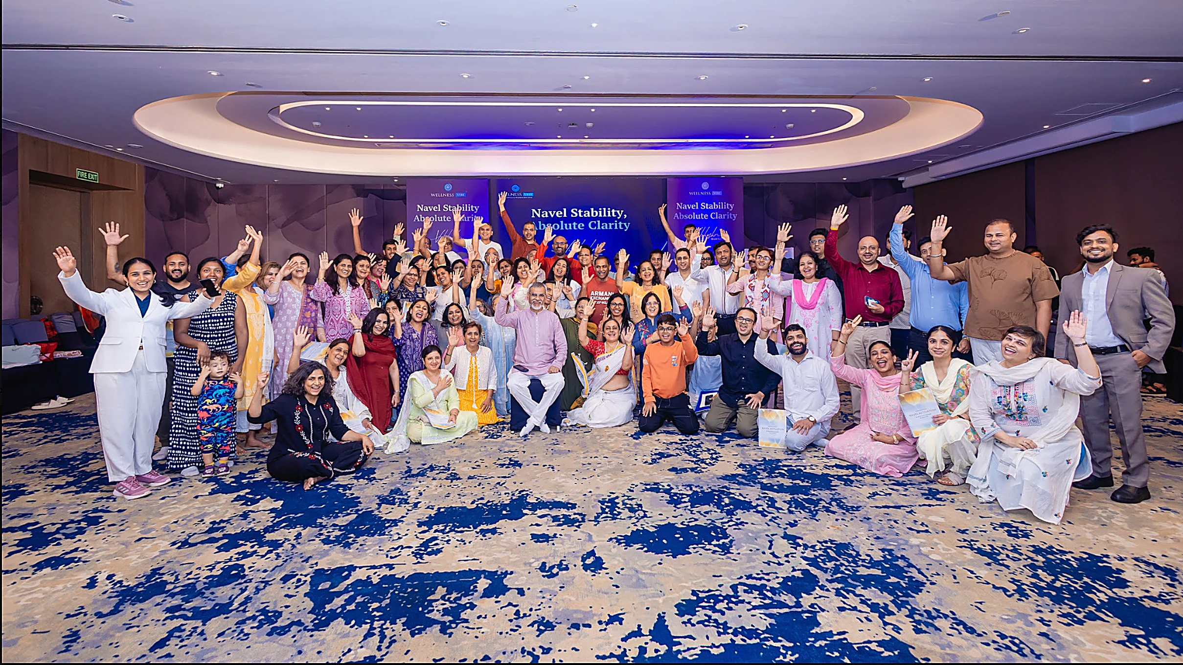 Crowd of workshop participants celebrating with raised hands
