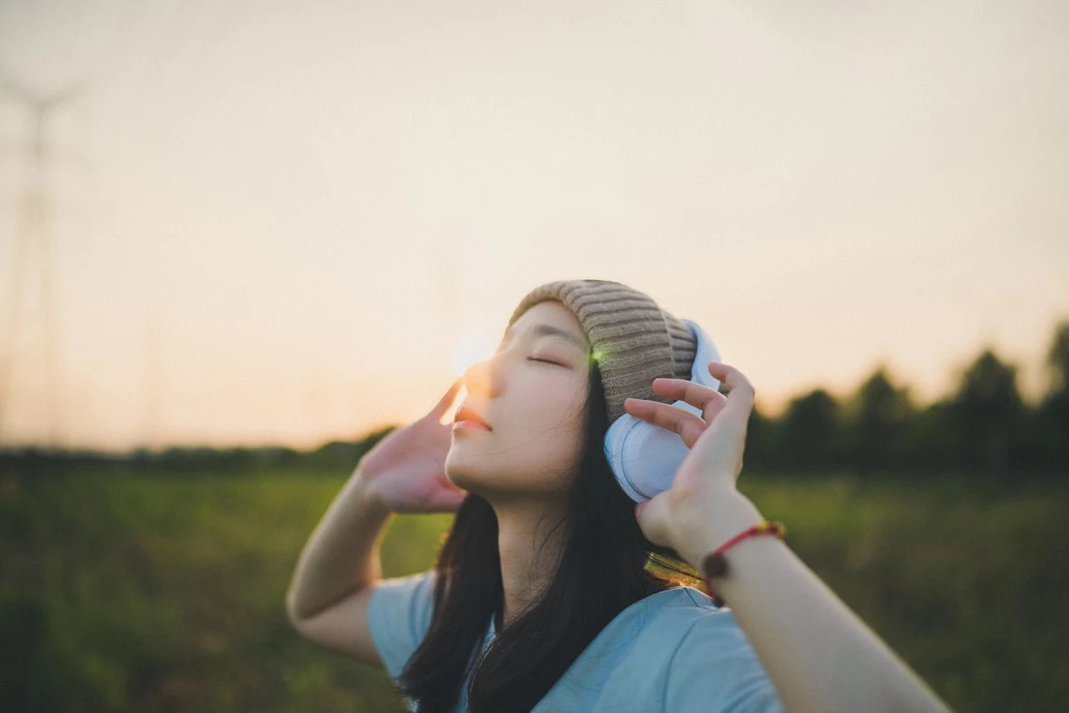 Person wearing headphones listening outdoors